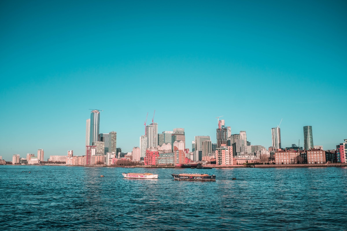 city skyline across body of water during daytime - family trip to London top neighborhoods