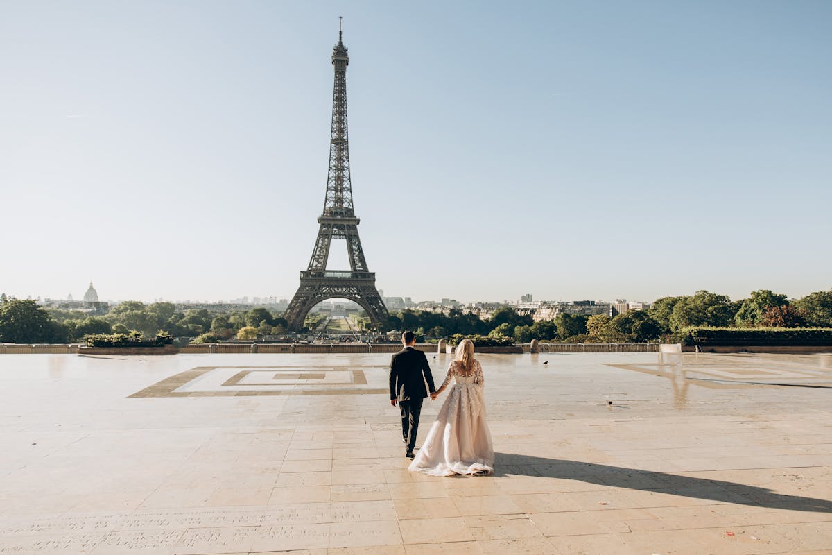 Woman and Man Walking in Park in Front of Eiffel Tower - day trips from Paris