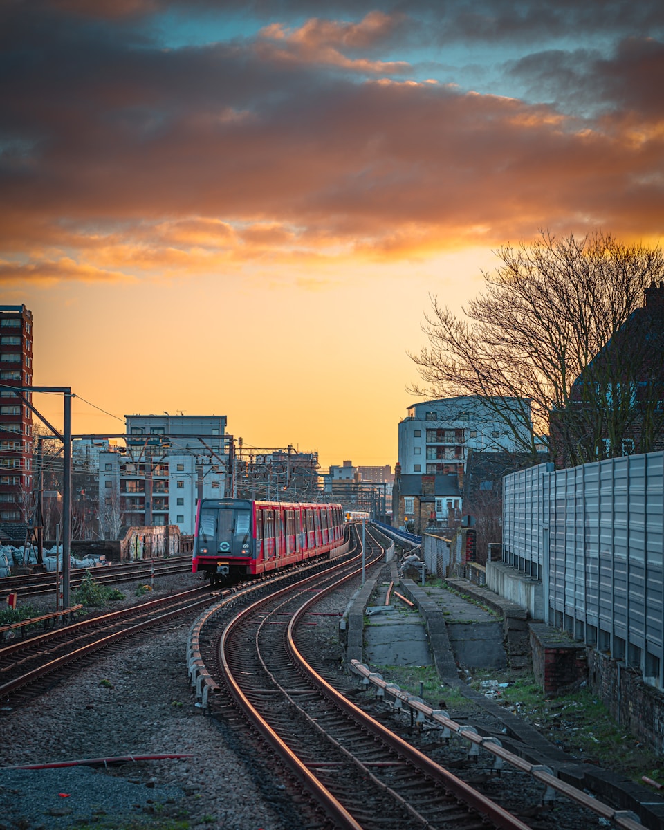 train rail near city buildings during daytime - London Transportation