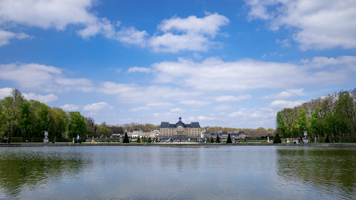 A large lake with a large building in the middle - day trips from Paris