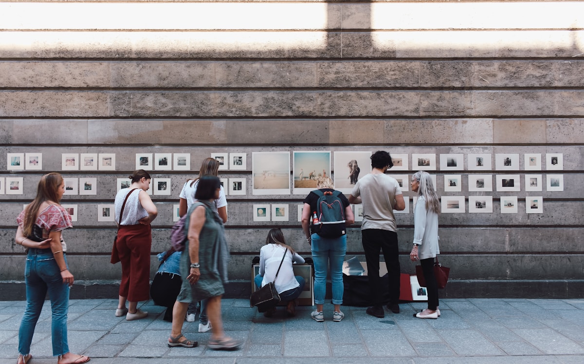 people beside brown wall - Street Art Tour Paris