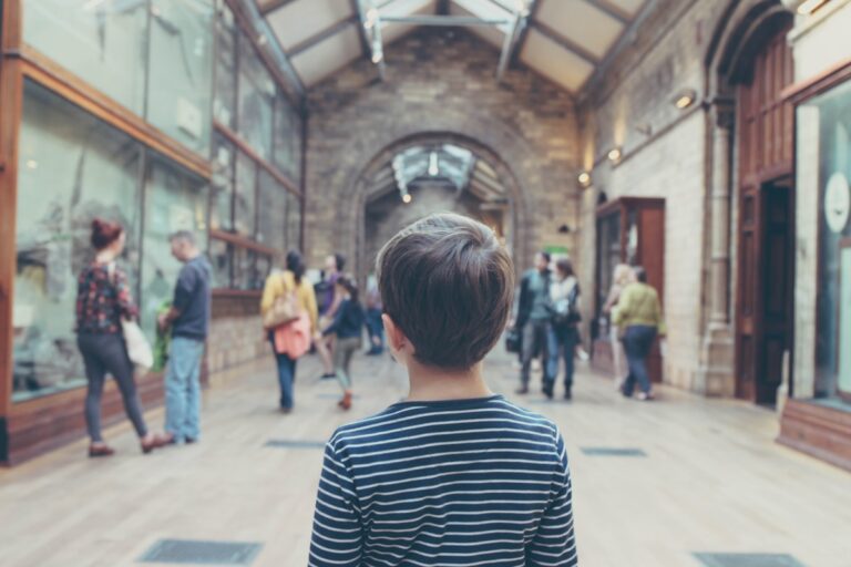 boy standing inside closed room - Adam enjoyed especially hearing more about dinosaurs and insects.