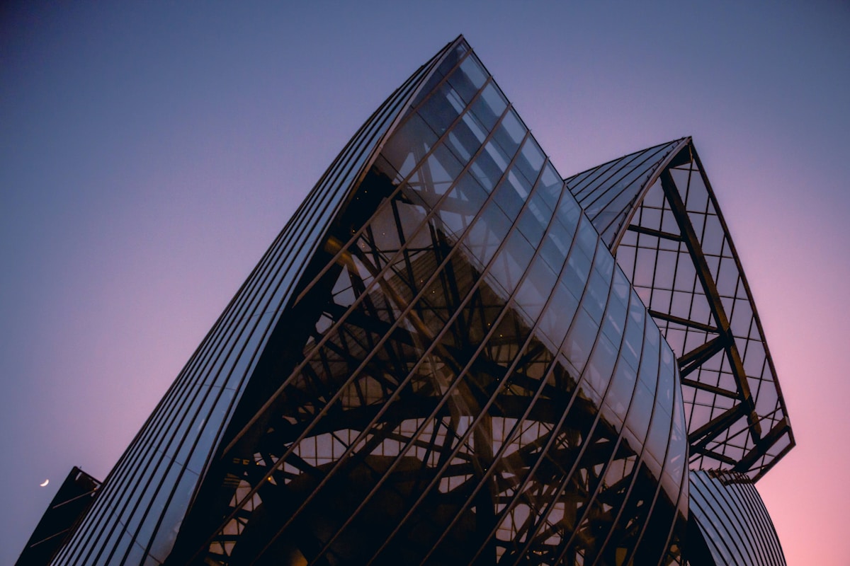 a very tall building with a sky background - Fondation Louis Vuitton Paris