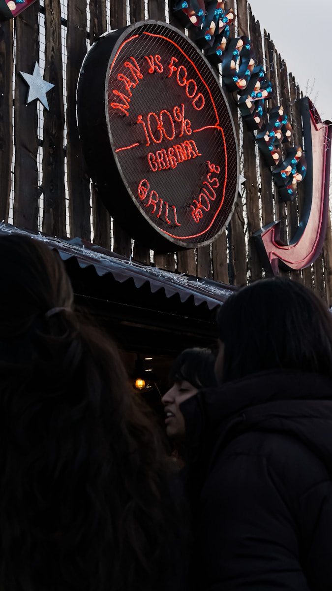 a group of people standing outside of a building - London Food