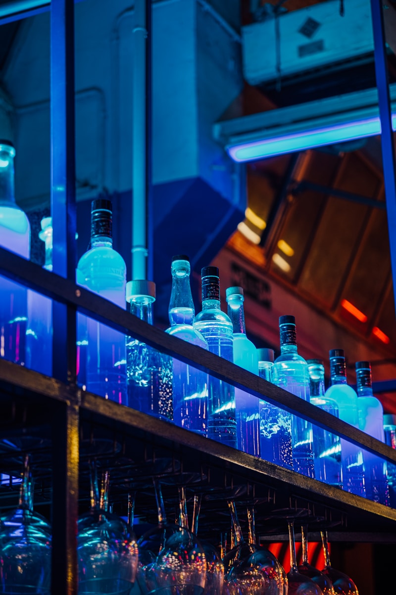 a shelf filled with lots of bottles and glasses - food and wine guide Paris