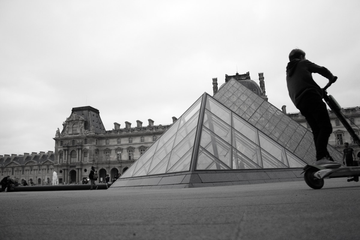 man riding on electric scooter in Paris