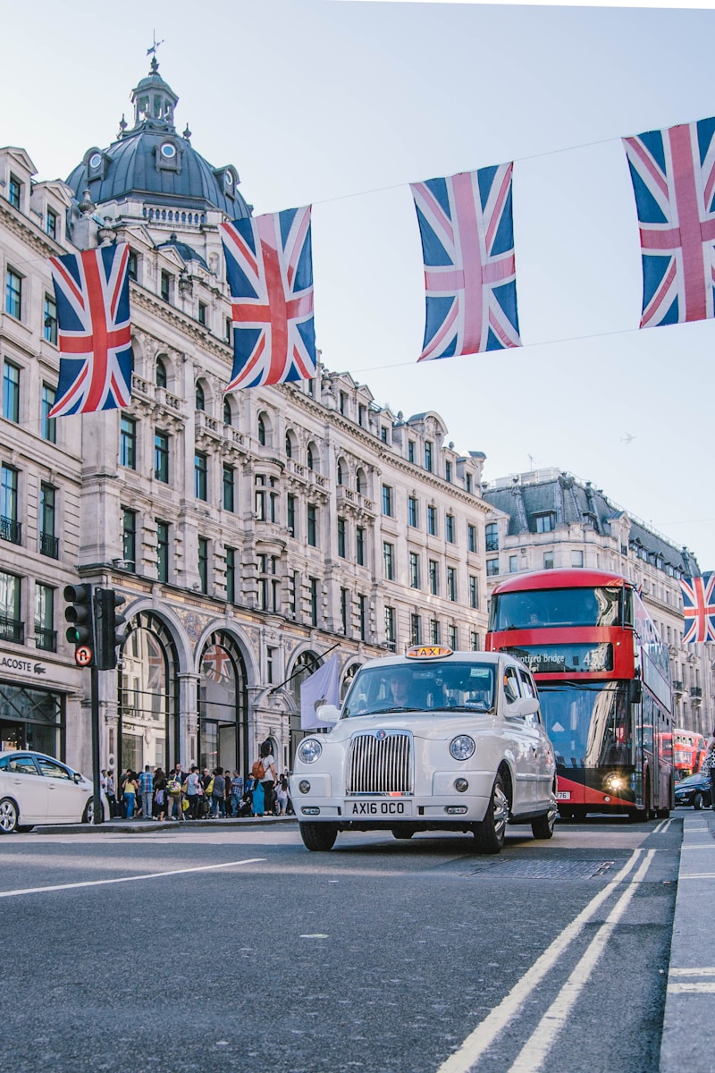 photo of car and bus near castle - Trip to London