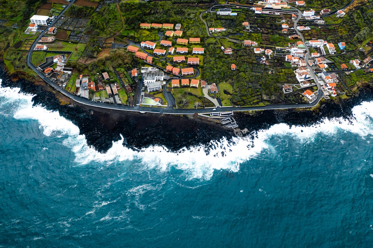 aerial view of houses near body of water during daytime - Azores Portugal Travel Guide