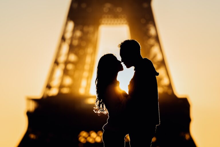 silhouette of man and woman kissing during sunset - romantic Paris