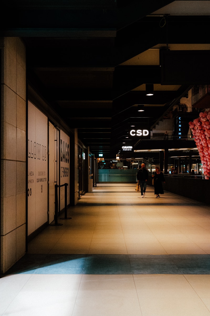 A person is walking down a long hallway - shopping in London