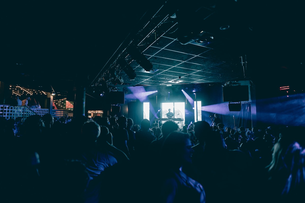 a crowd of people standing around a stage - Clubbing in Paris