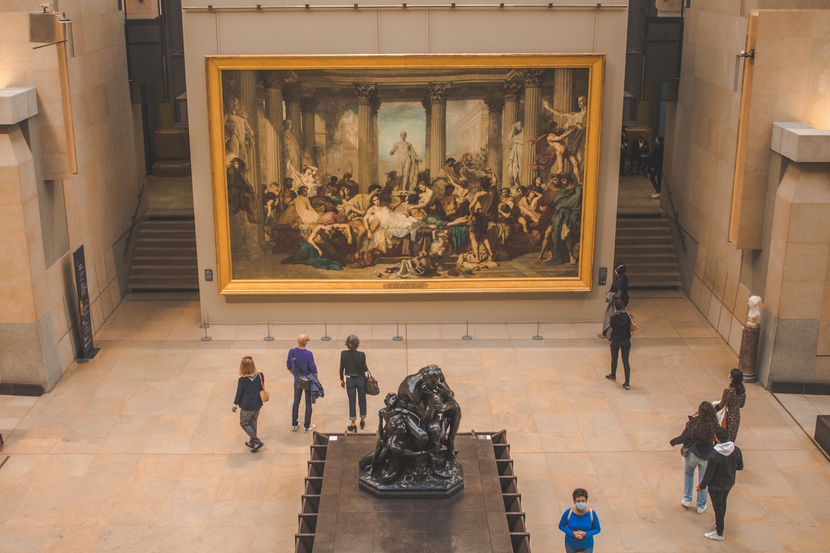 a group of people looking at a painting in a museum - Musée d'Orsay Paris