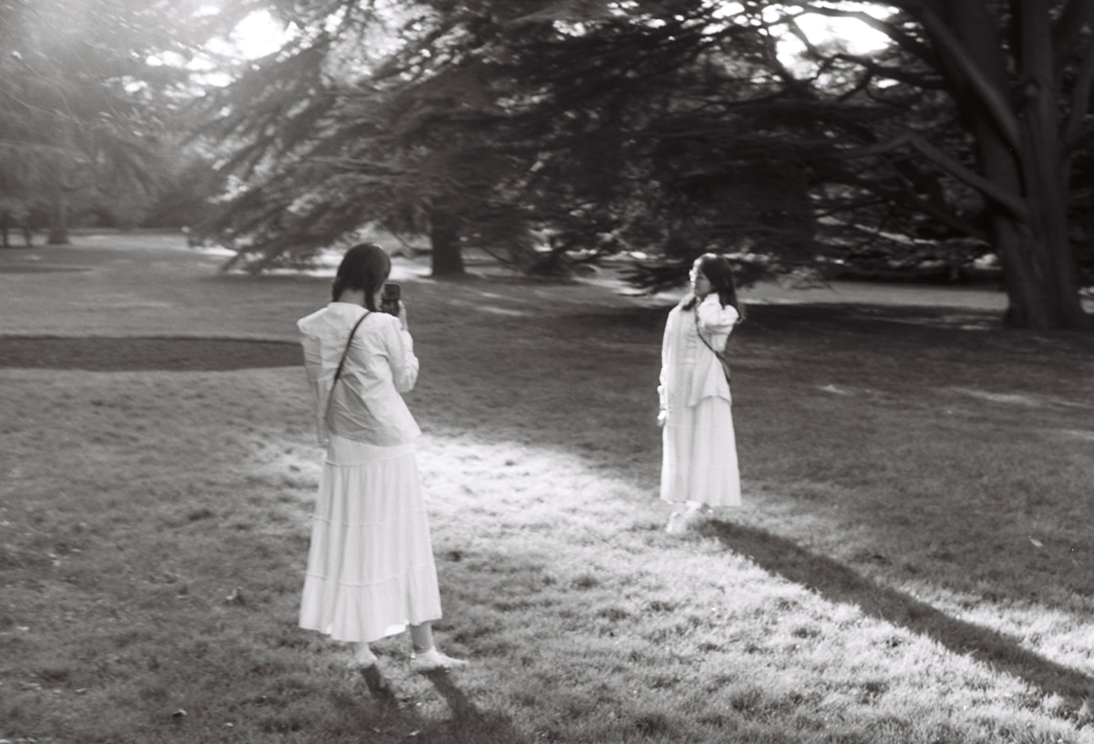 a black and white photo of two women in a park - Greenwich Park London UK