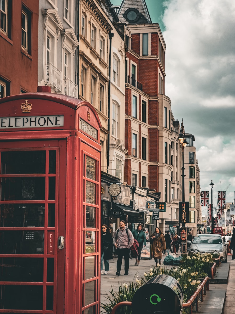 a red telephone booth sitting on the side of a road - where to visit in London