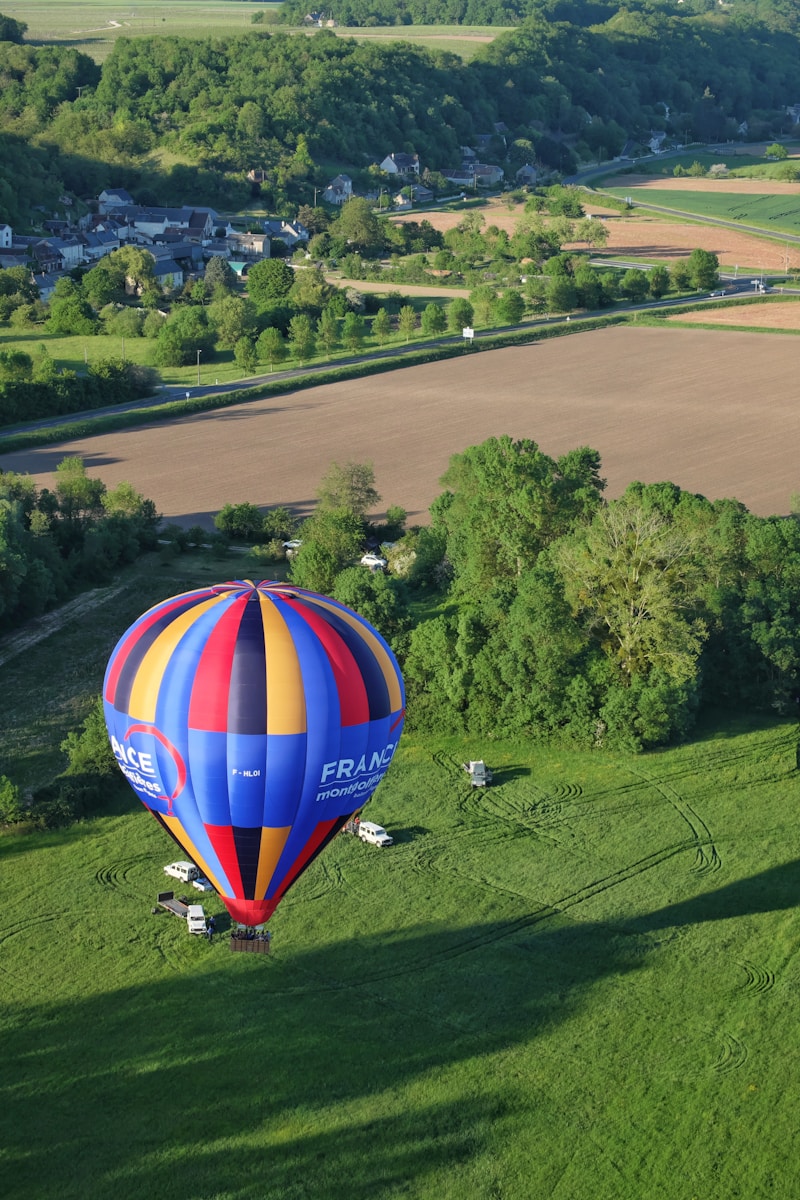 hot air balloon on green grass field during daytime - day trip from Paris