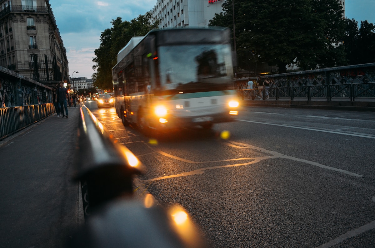 white bus on road at night - Paris transport