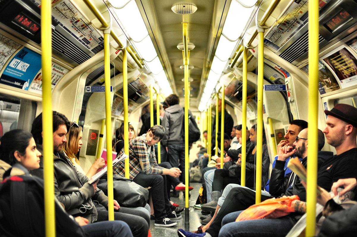 photo of group on people sitting inside train - best tim to visit London