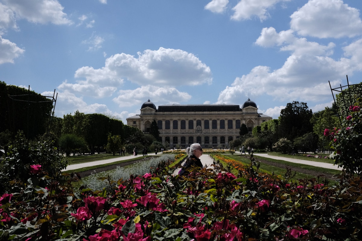 a view of a large building with a garden in front of it - Jardin des Plantes Paris France