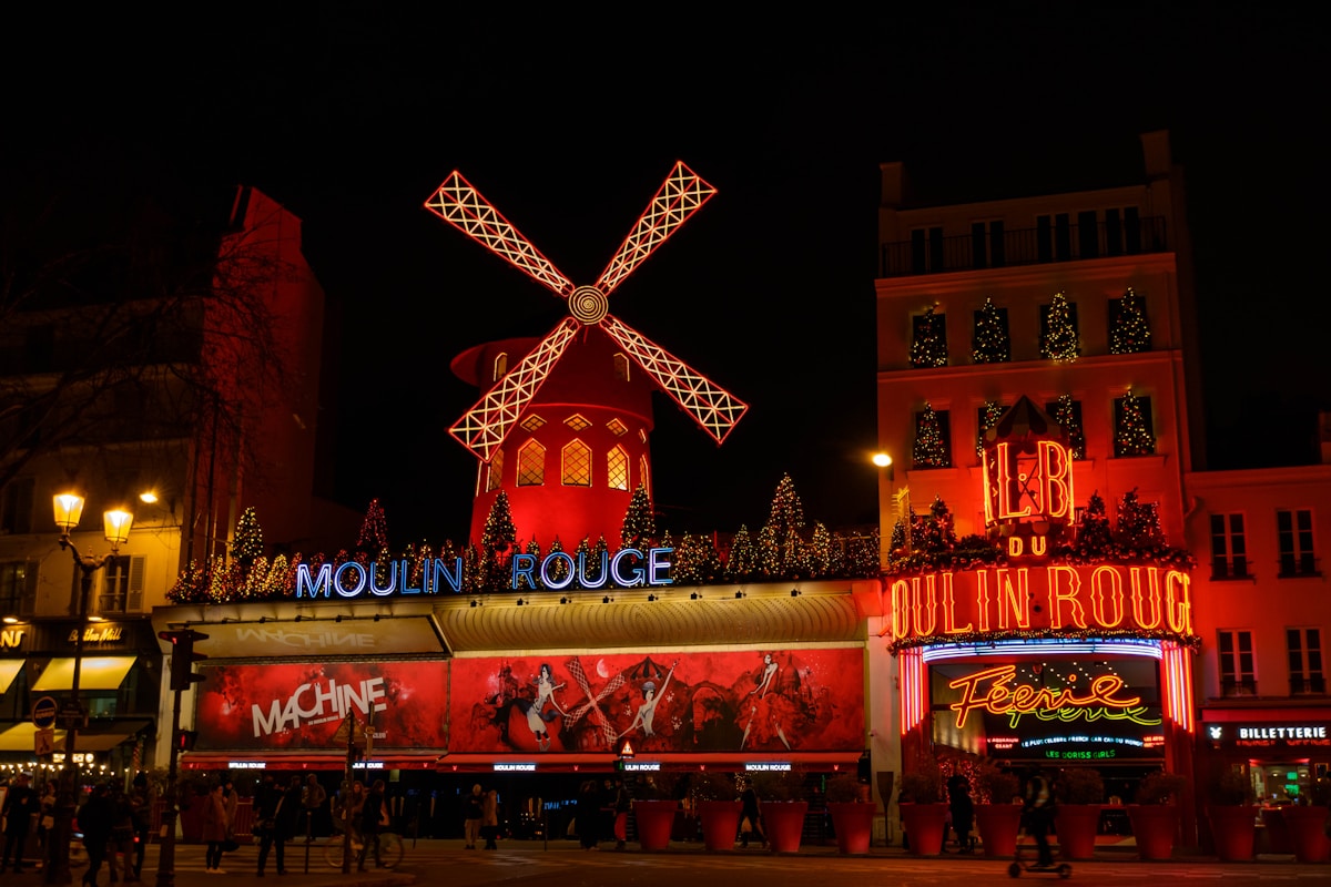 red and yellow lighted building during nighttime - Moulin Rouge Paris France