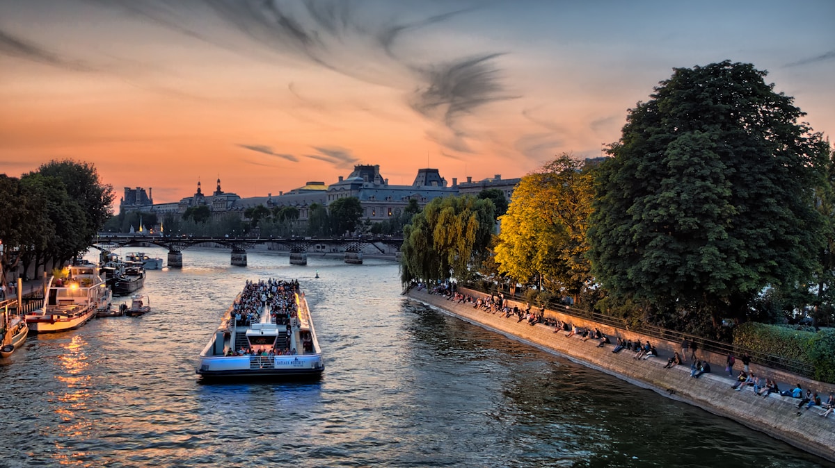 boat on body of water near structures - Romantic Getaway in Paris