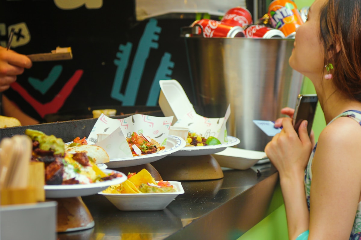 person holding white ceramic bowl with food - Shopping in London