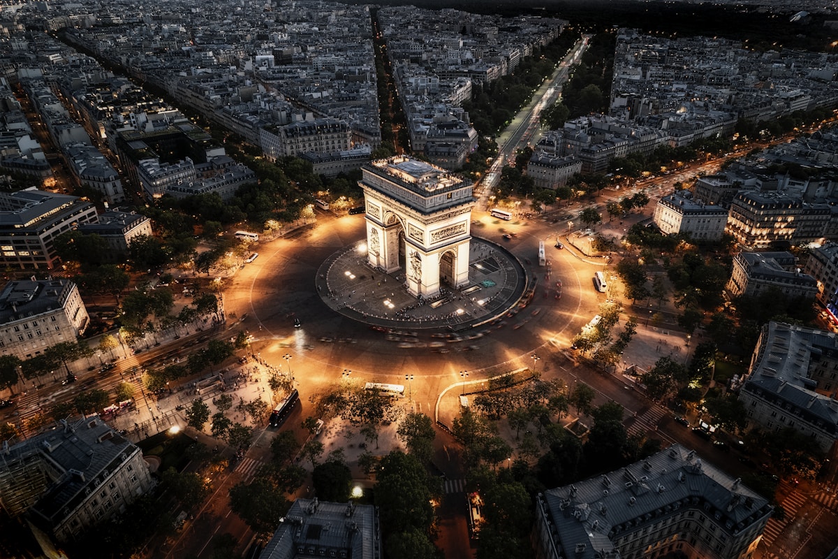 an aerial view of Arc de Triomphe Paris at night