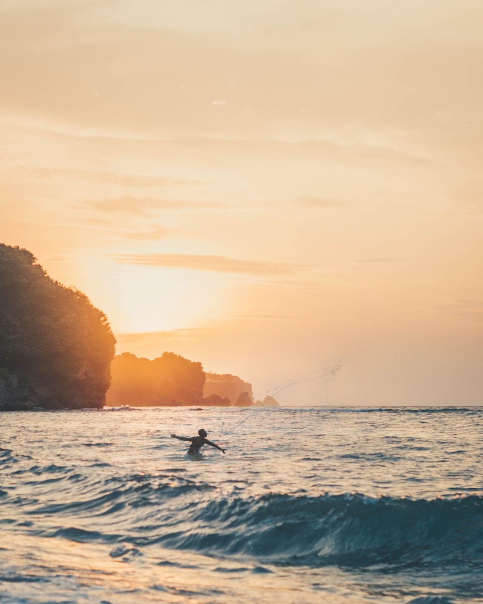 person submerge on water near islands - Bingin Beach Uluwatu Bali