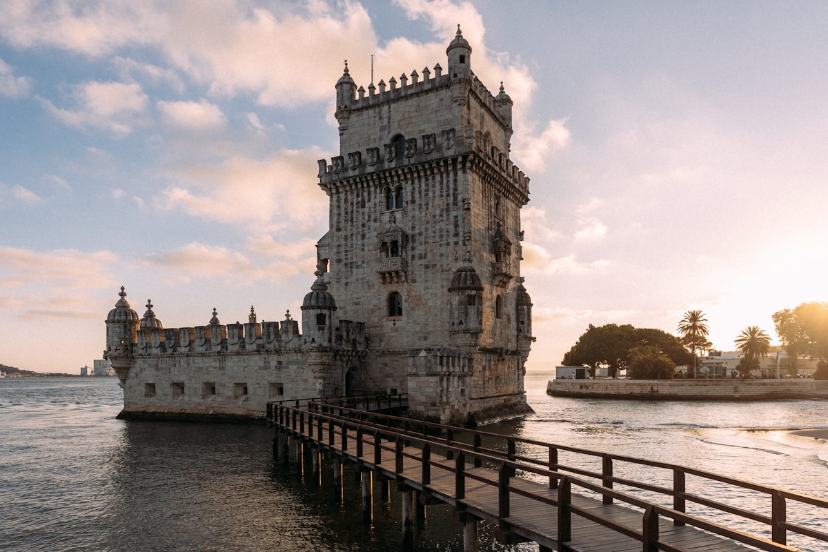 a large tower sitting on top of a body of water - Spring in Lisbon - Belém Tower, Av. Brasília, Lisbon, Portugal