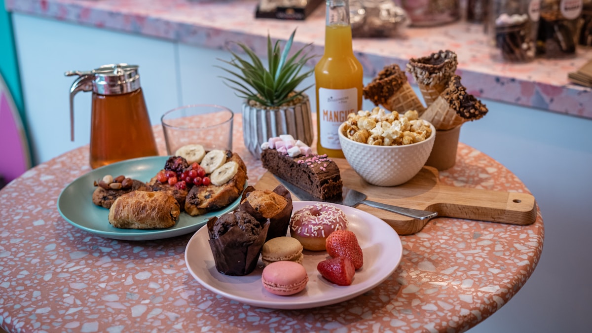 a table with plates of desserts - French Foods