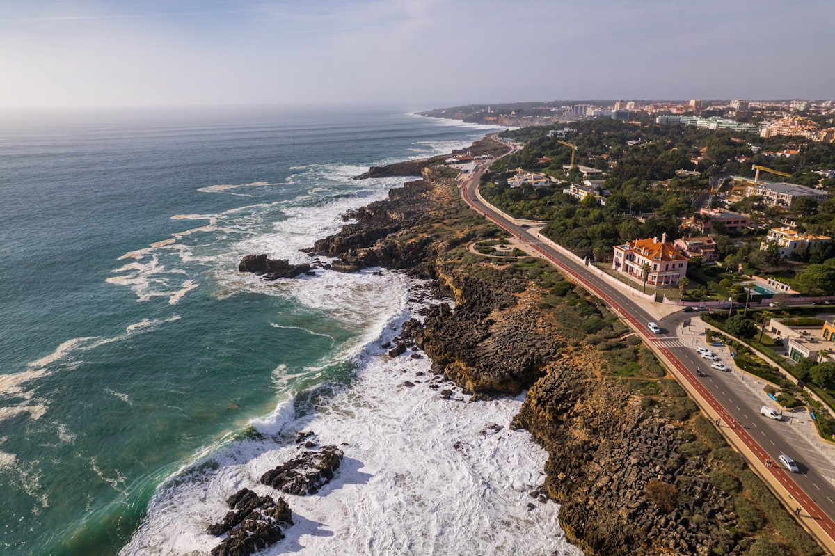 an aerial view of a highway next to the ocean - Boca do Inferno, Avenida Rei Humberto II de Itália, Cascais, Portugal