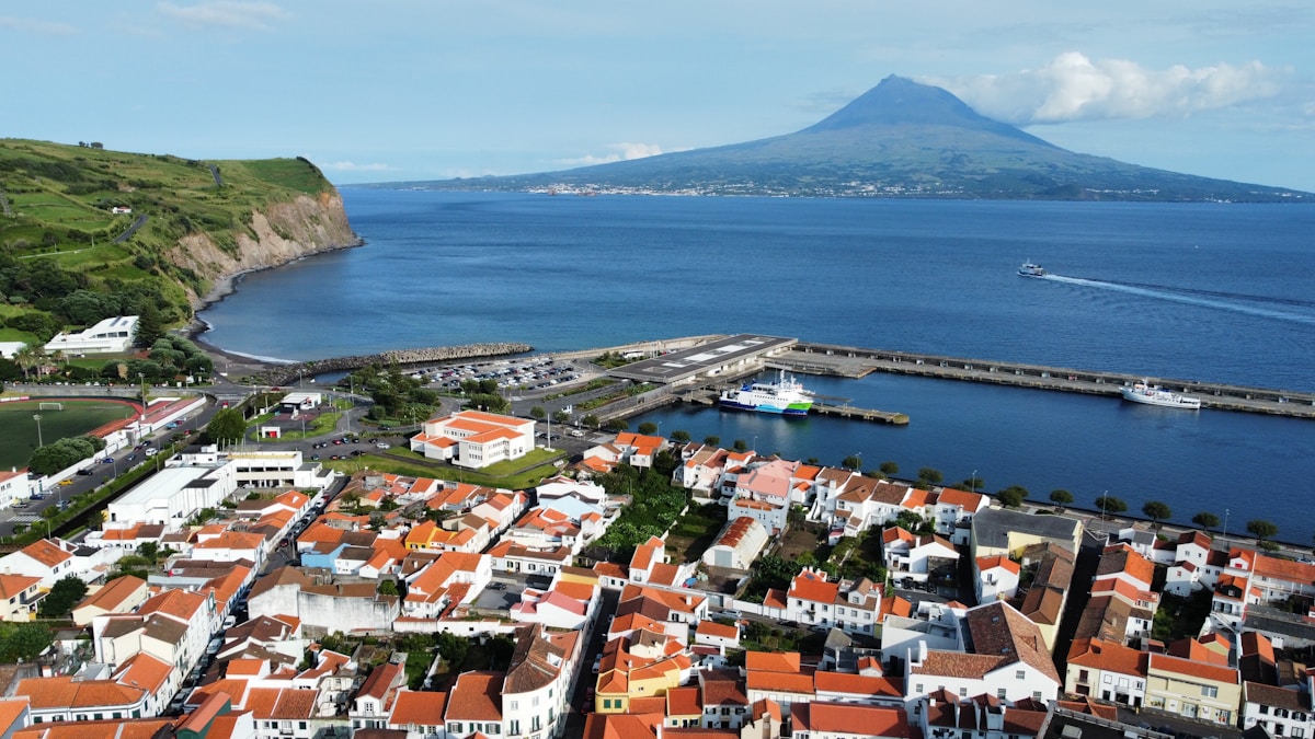 an aerial view of a city with a mountain in the background - Faial Island, Azores, Portugal