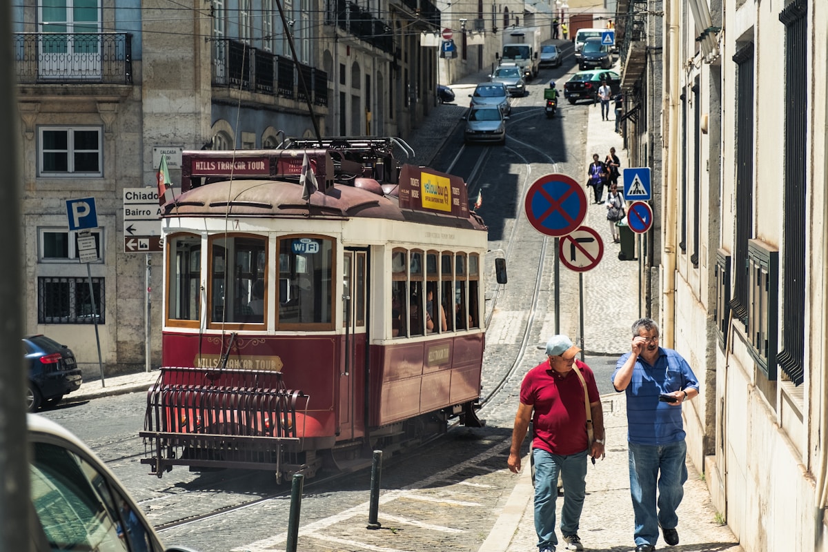 people near a train during daytime - walking around Lisbon