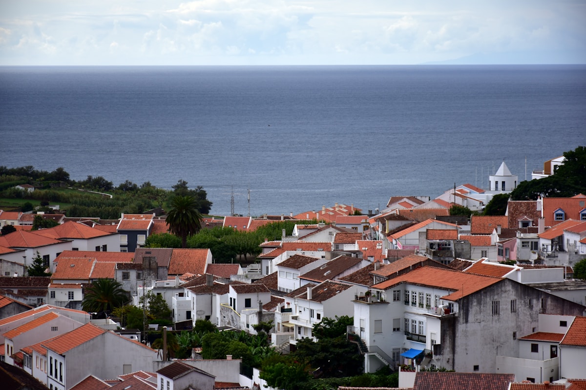 A view of a city with a body of water in the background - Terceira Island, Azores, Portugal