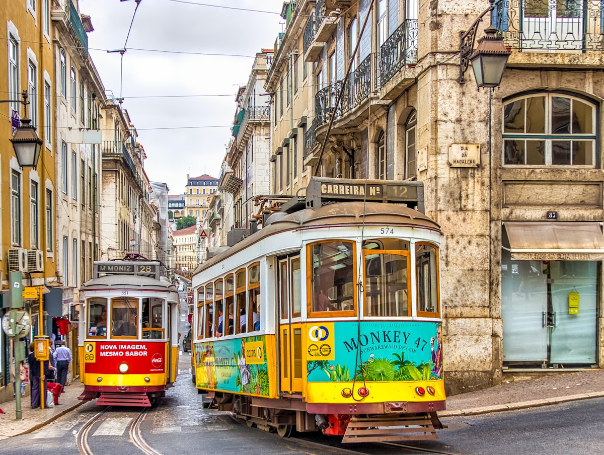 yellow and white tram on street during daytime - Lisbon Tram