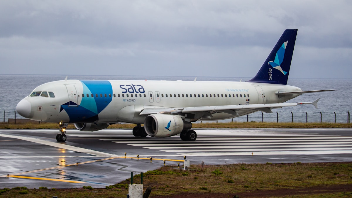 white and blue airplane on airport during daytime - Azores Airport - Pico Island Airport