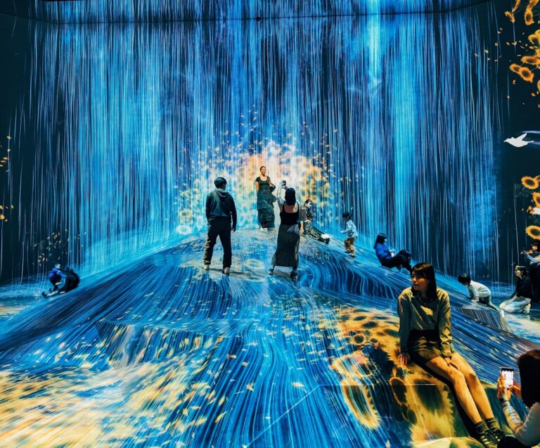 A group of people standing in a blue room - Museums in Tokyo