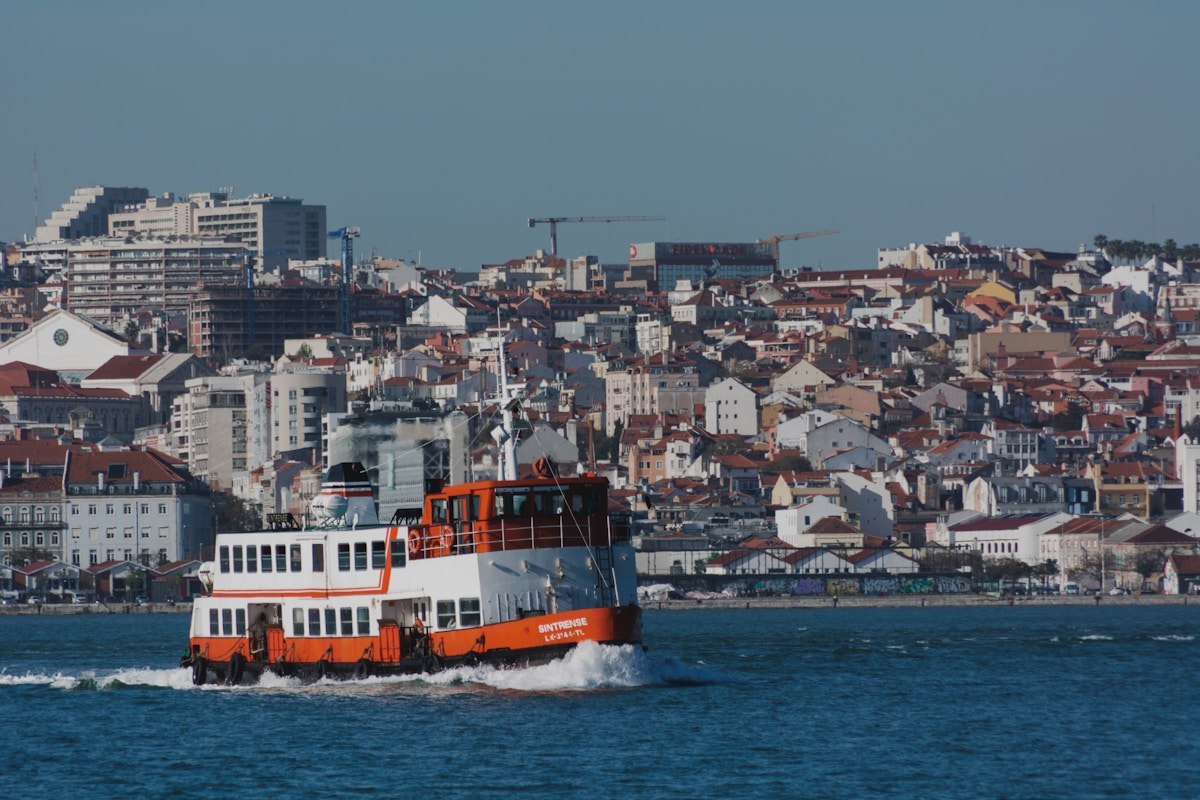 white and brown boat on sea during daytime - boat and ferry in Lisbon