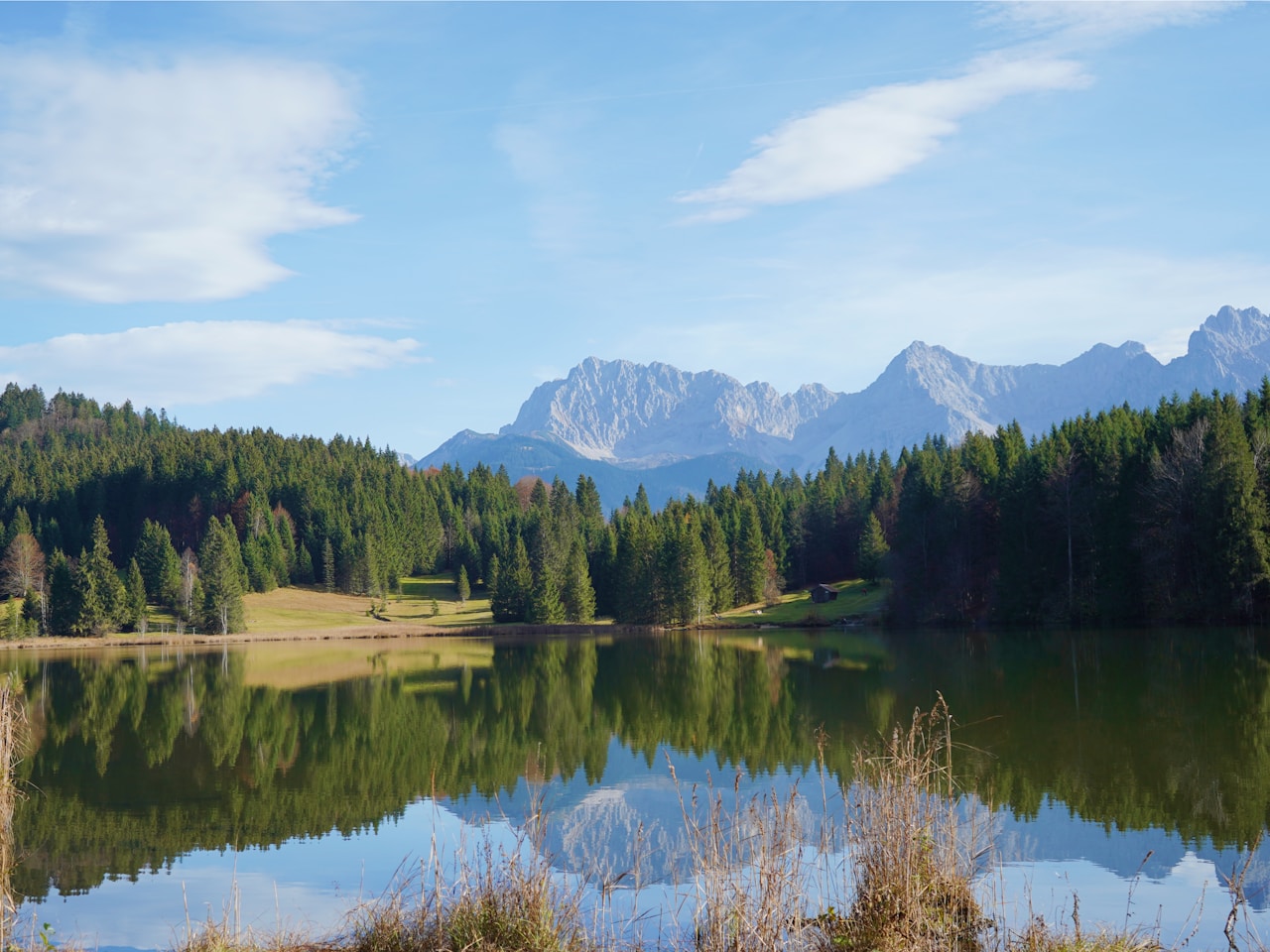 Best Day Trips From Munich, a lake with trees and mountains in the background