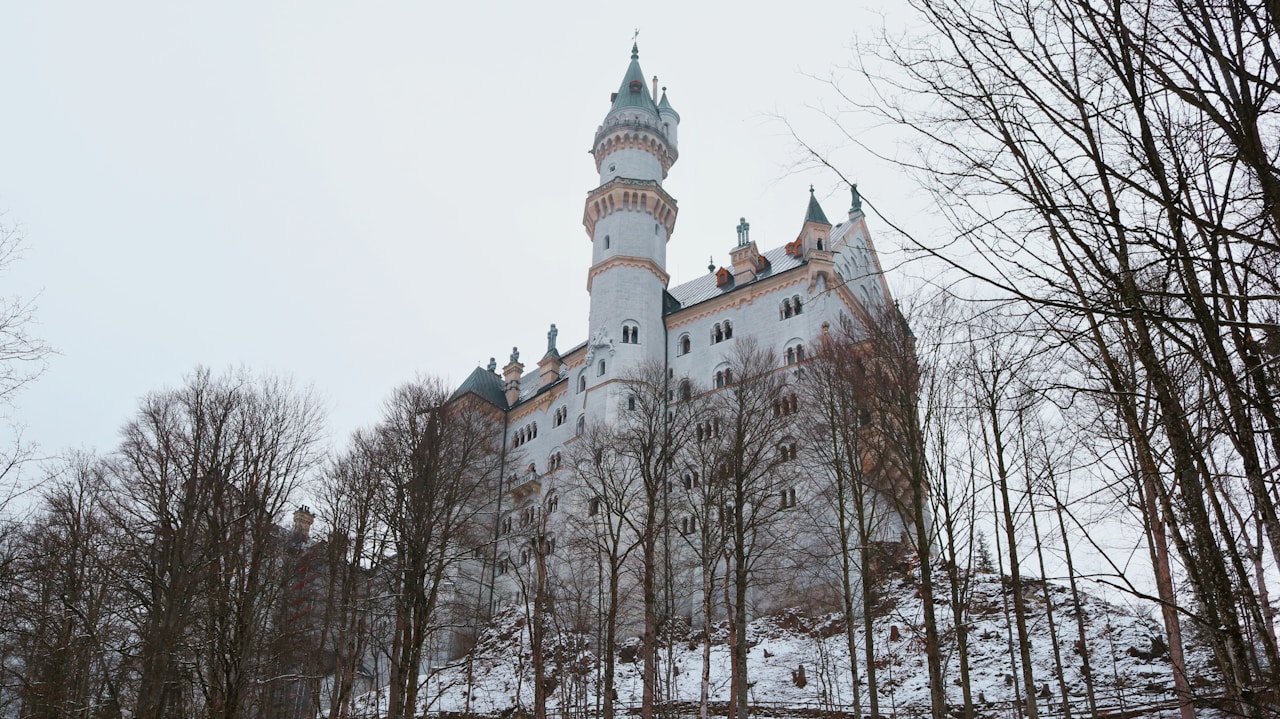 Best Day Trips From Munich, A large white castle with a clock tower