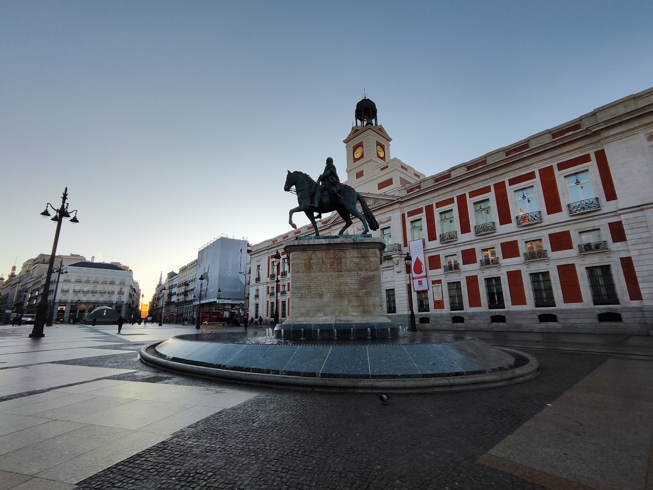 a statue of a man riding a horse in front of a building