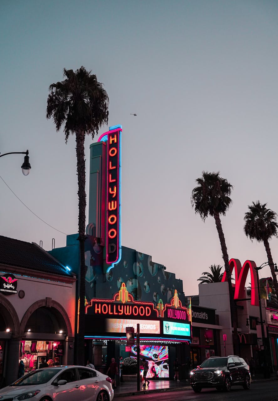 Evening view of the iconic Hollywood signage amidst urban cityscape in Los Angeles.