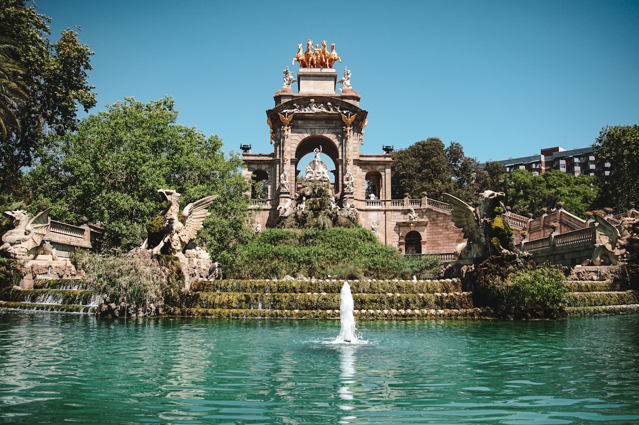 a fountain in a park surrounded by trees