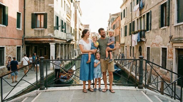 Family enjoying a sunny day in Venice, standing on a bridge with a picturesque canal and historic buildings in the background.