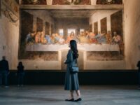 Kannaya Nareswari admiring Leonardo da Vinci's "The Last Supper" mural in a serene museum setting, surrounded by other visitors.