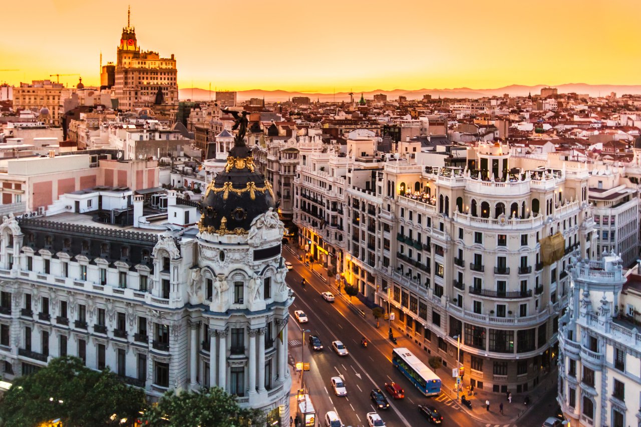 Stunning sunset view over Madrid’s vibrant cityscape, showcasing historical architecture and lively streets.