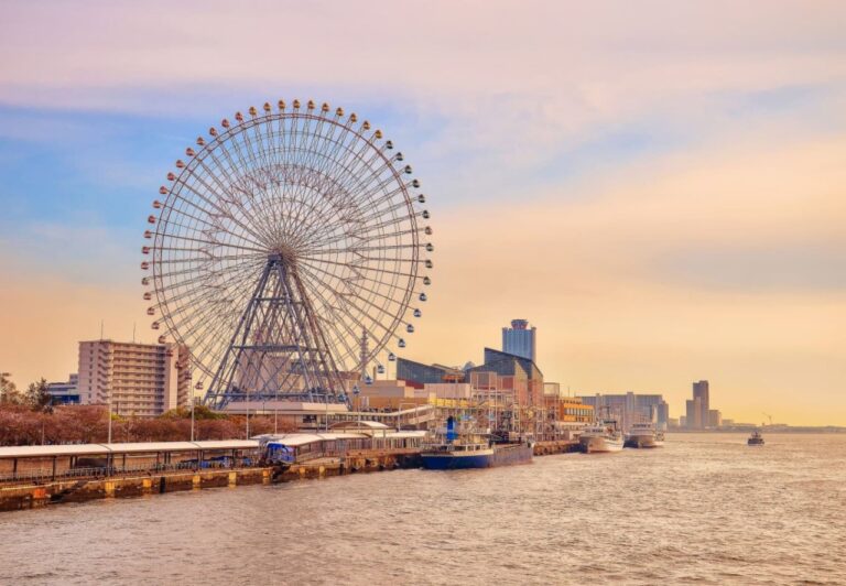 Ferris wheel towering over a scenic riverside promenade, capturing the vibrancy of urban life and waterfront leisure.