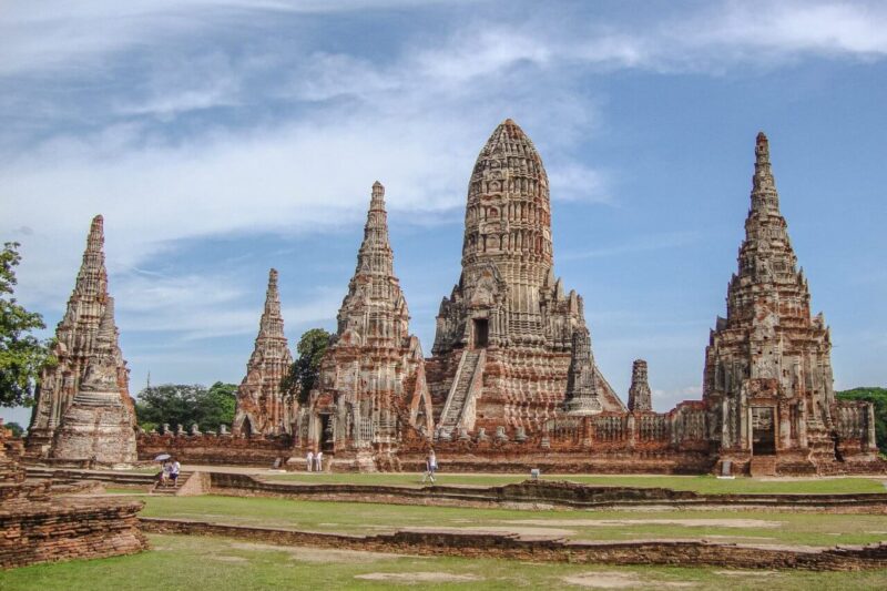 Historic Ayutthaya temple complex featuring ancient spires, showcasing Thailand’s rich cultural heritage and architectural beauty.