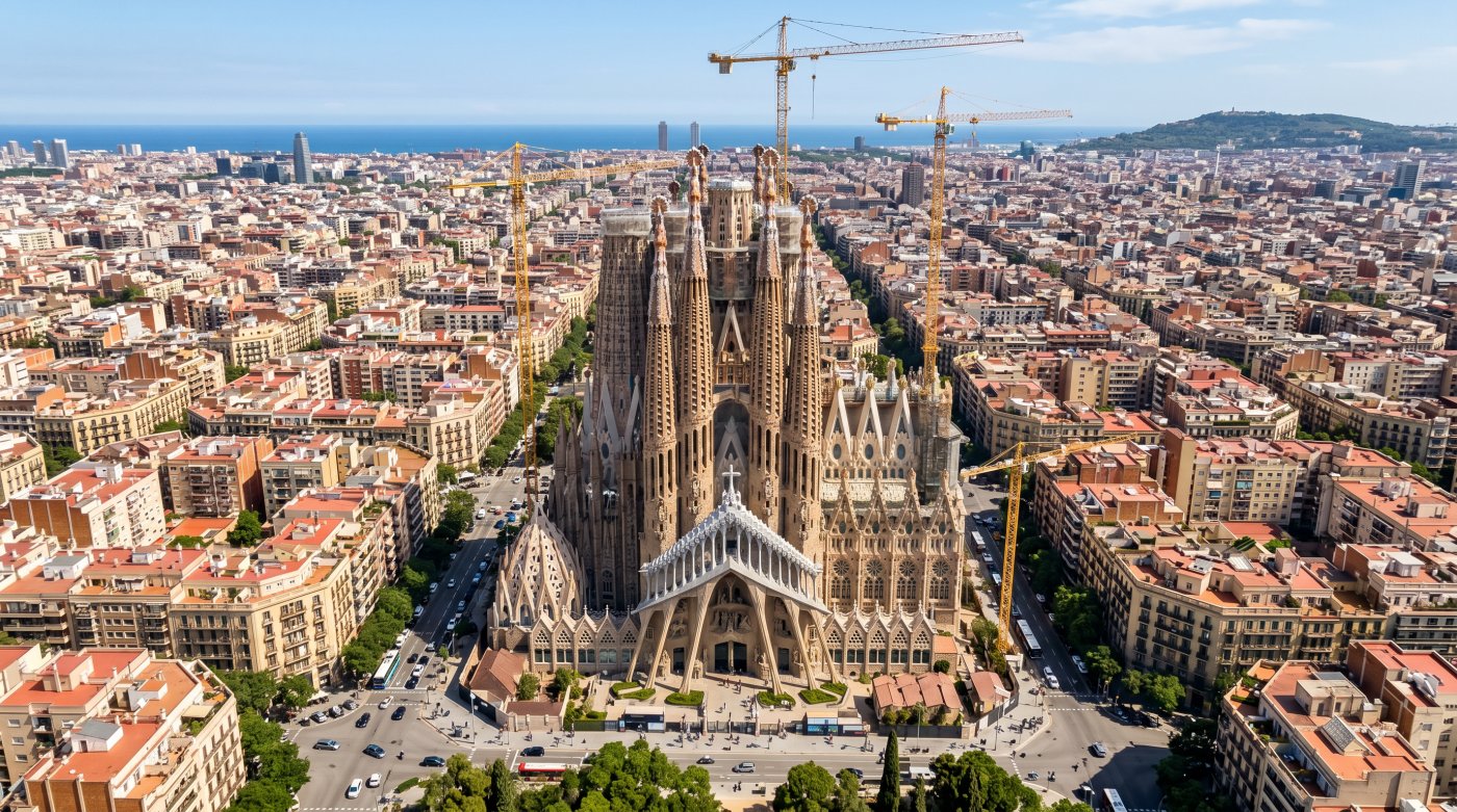 Aerial view of Barcelona's Sagrada Familia, showcasing its intricate architecture amidst a vibrant city landscape.